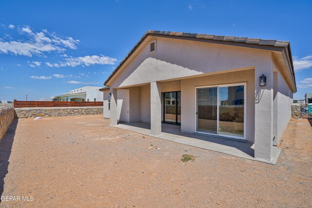 back of house featuring a patio area, stucco siding, and a fenced backyard