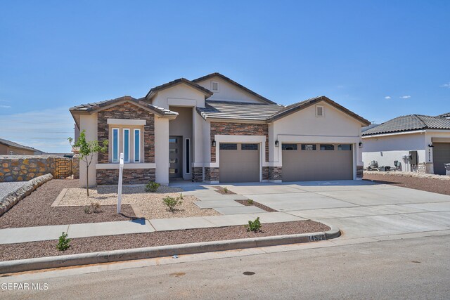 view of front of property featuring stucco siding, stone siding, concrete driveway, and an attached garage