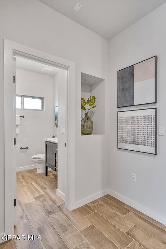 interior space with wood finish floors and baseboards