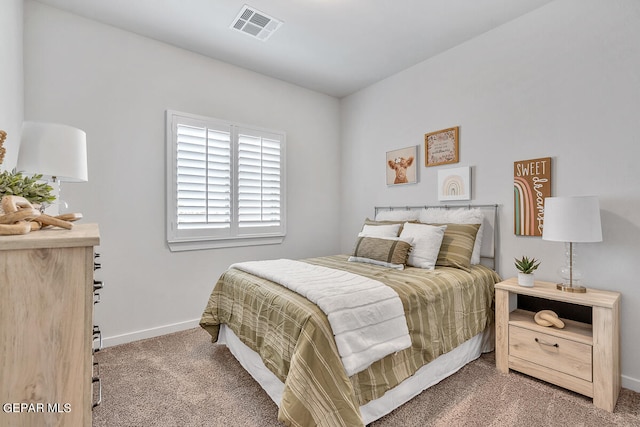 carpeted bedroom with baseboards and visible vents