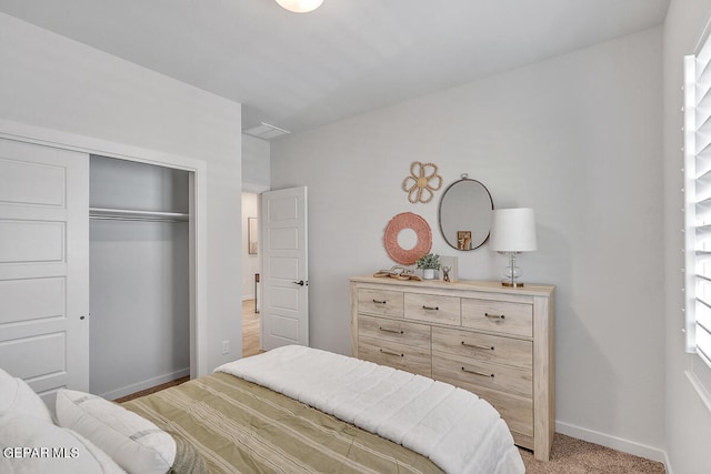 bedroom with light carpet and a closet