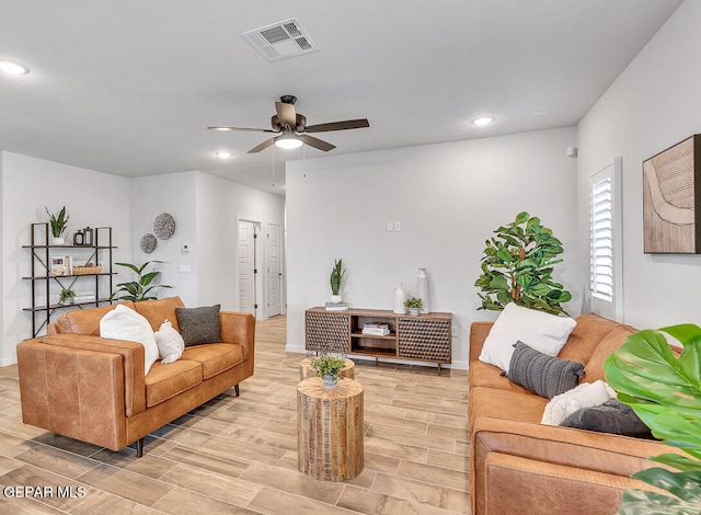 living area featuring recessed lighting, visible vents, a ceiling fan, wood tiled floor, and baseboards