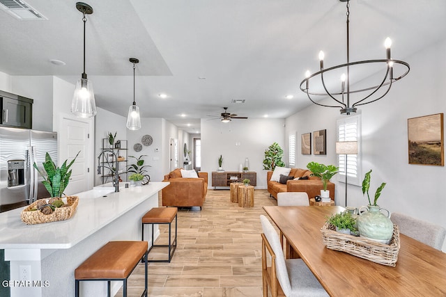 dining room with plenty of natural light, light wood-type flooring, and ceiling fan