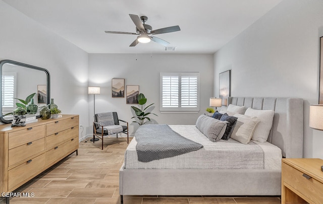 bedroom featuring a ceiling fan and wood tiled floor