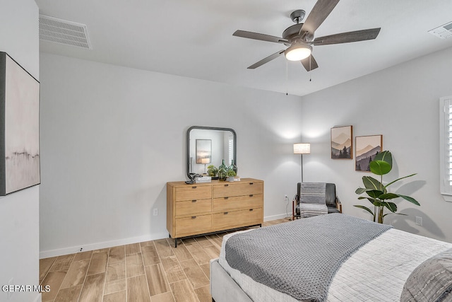 bedroom with light wood-style floors, baseboards, visible vents, and a ceiling fan