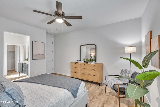 bedroom with a ceiling fan, wood tiled floor, visible vents, and baseboards