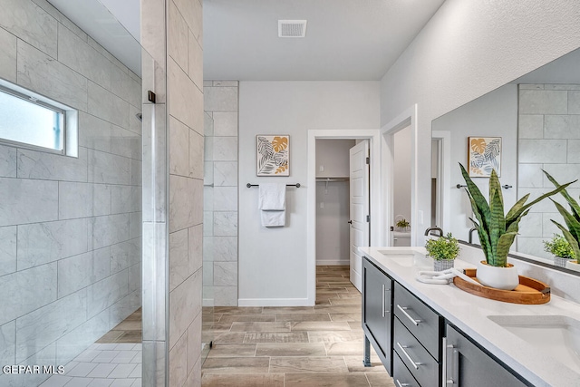 bathroom featuring vanity and a tile shower