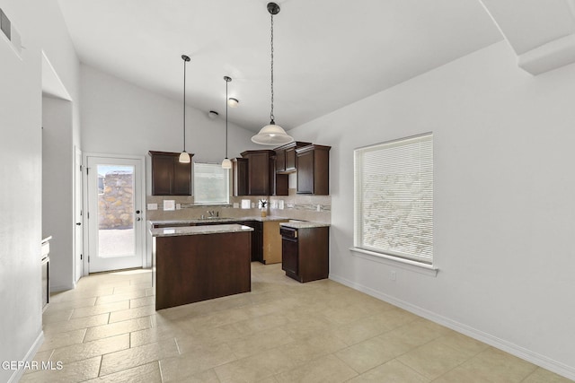 kitchen featuring dark brown cabinets, sink, pendant lighting, high vaulted ceiling, and a center island