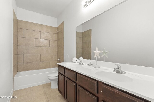 full bathroom featuring tile patterned floors, vanity, toilet, and tiled shower / bath