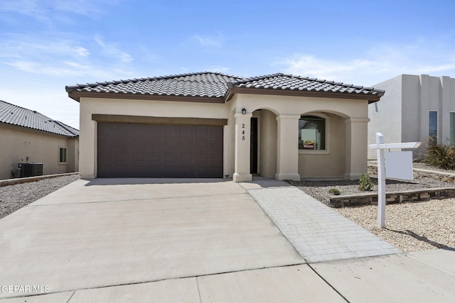 mediterranean / spanish-style house with a garage