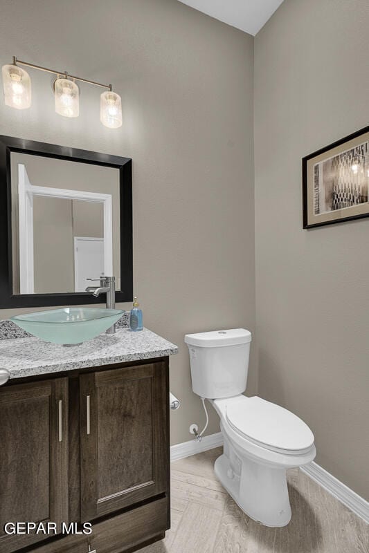 bathroom featuring toilet and vanity