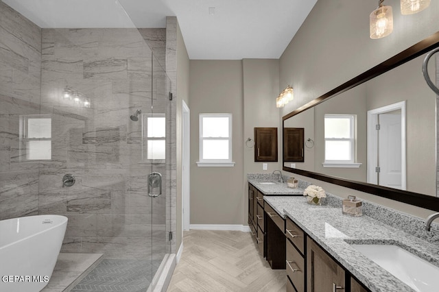 bathroom featuring parquet flooring, independent shower and bath, and double vanity