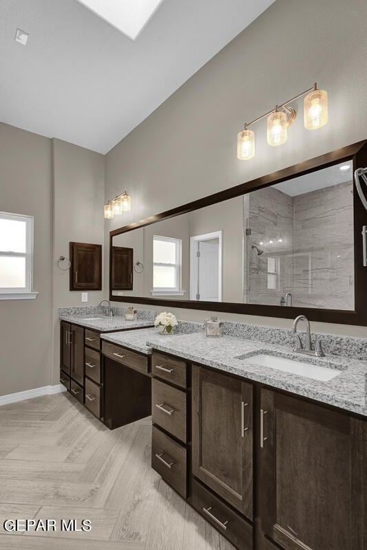 bathroom featuring double sink vanity, plenty of natural light, and parquet floors