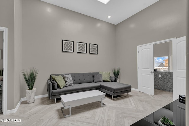 living room with a high ceiling and light parquet flooring