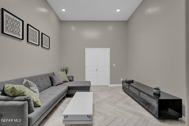 living room featuring a high ceiling and light parquet floors