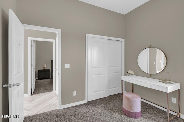 unfurnished bedroom featuring parquet flooring and a closet