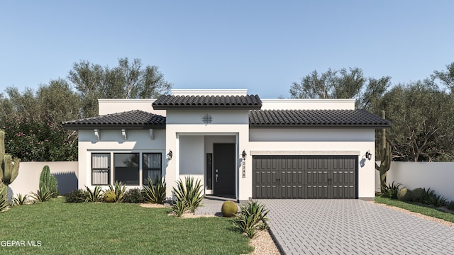 mediterranean / spanish house with a front yard and a garage