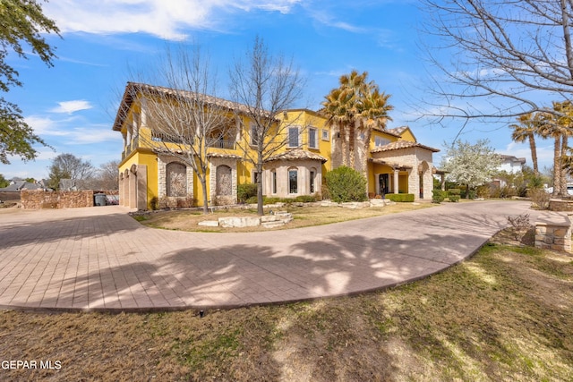 mediterranean / spanish-style house featuring a front lawn