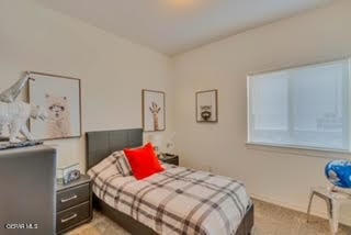 bedroom featuring light colored carpet