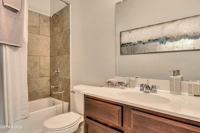 full bathroom featuring tiled shower / bath combo, toilet, and vanity