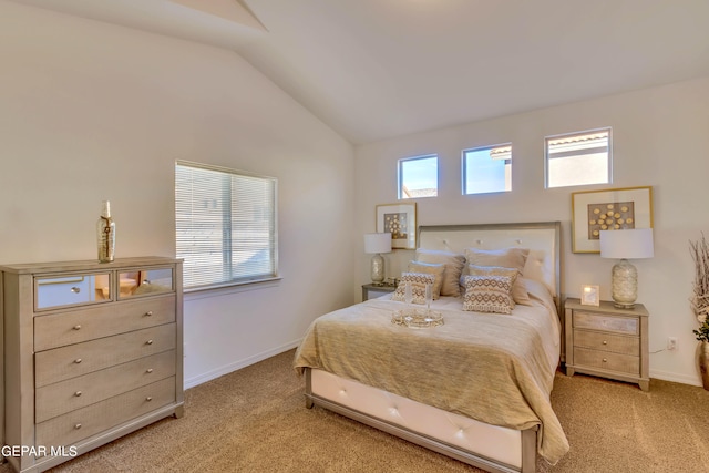 bedroom featuring light carpet and lofted ceiling