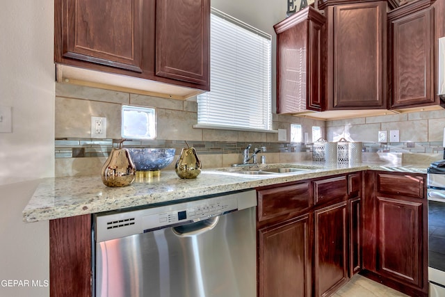 kitchen featuring light tile flooring, sink, backsplash, dishwasher, and light stone counters