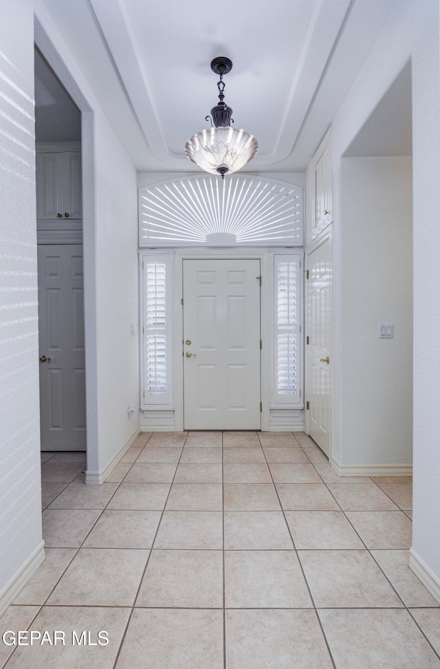 entryway featuring a notable chandelier and light tile patterned floors