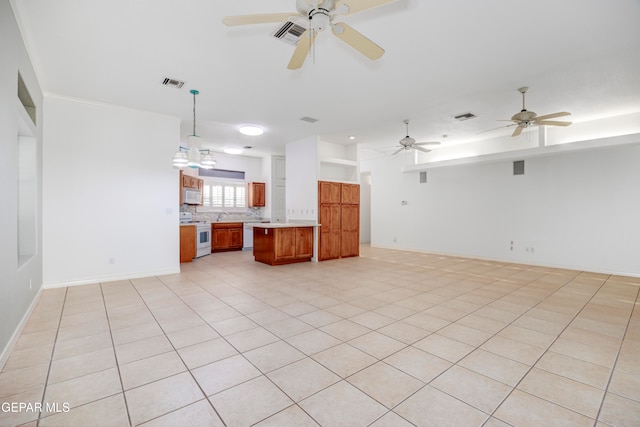 interior space with light tile patterned floors, ceiling fan, and sink