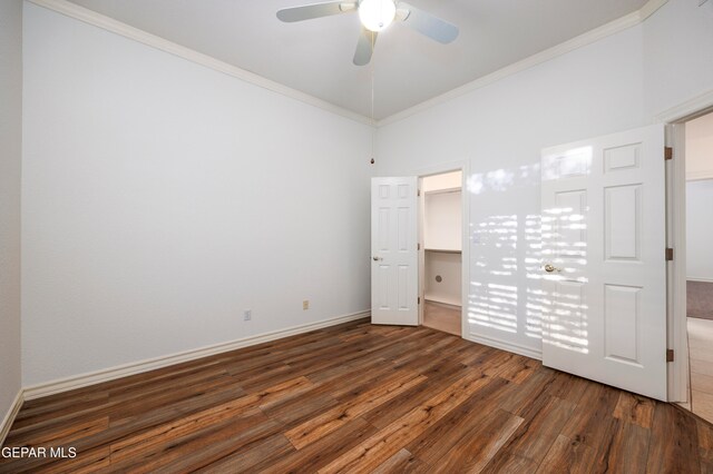 unfurnished bedroom featuring dark hardwood / wood-style floors, ceiling fan, and ornamental molding