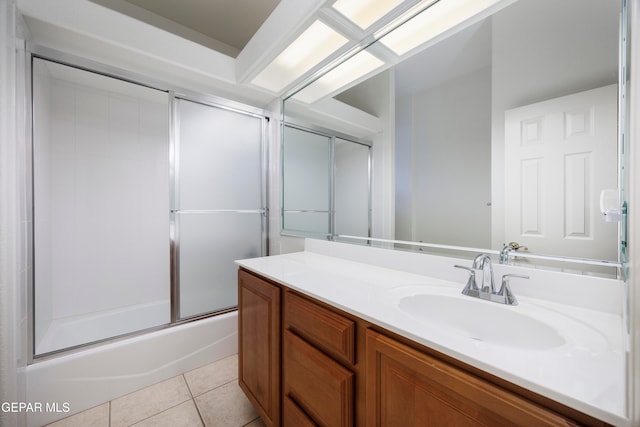 bathroom featuring tile patterned floors, shower / bath combination with glass door, and vanity
