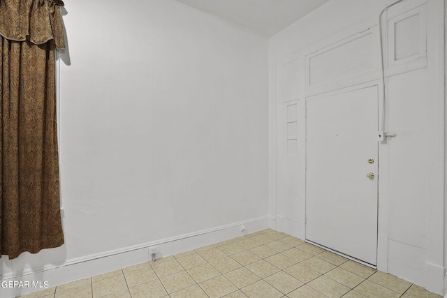 unfurnished room with light tile floors