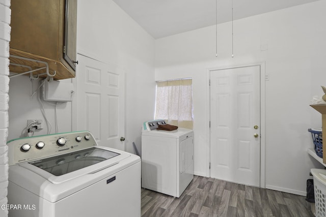 laundry area with washing machine and clothes dryer and dark hardwood / wood-style flooring