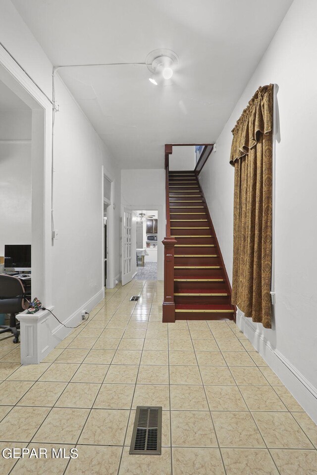 stairs with light tile floors