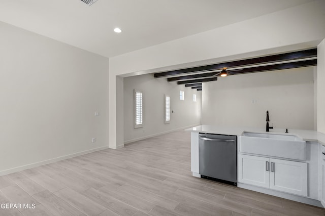 interior space featuring beamed ceiling, sink, light hardwood / wood-style floors, stainless steel dishwasher, and white cabinetry