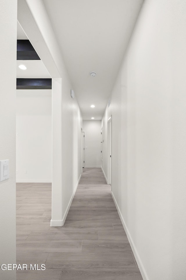 corridor featuring hardwood / wood-style floors