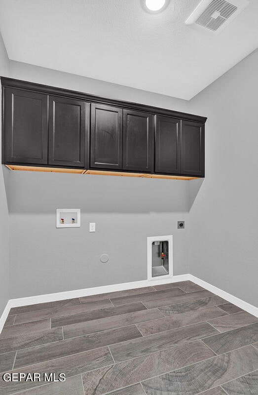 13357 Highworth Dr, El Paso, TX 79928 - clothes washing area with cabinets, washer hookup, electric dryer hookup, hookup for a gas dryer, and dark hardwood / wood-style flooring
