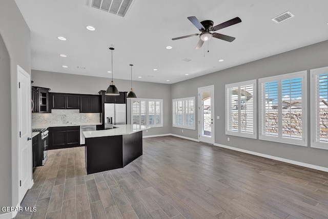 13357 Highworth Dr, El Paso, TX 79928 - kitchen with stainless steel appliances, ceiling fan, hardwood / wood-style flooring, a kitchen island, and hanging light fixtures