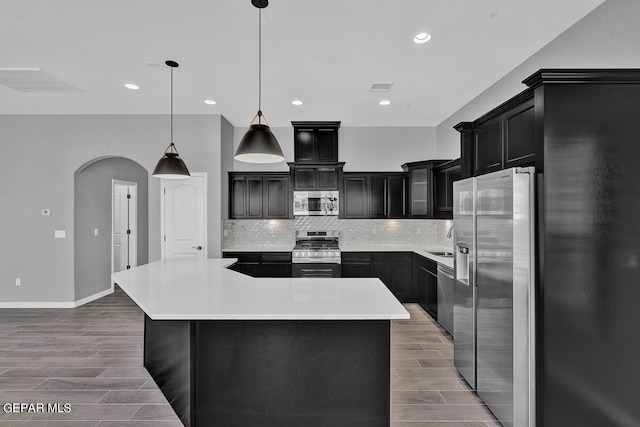 13357 Highworth Dr, El Paso, TX 79928 - kitchen featuring pendant lighting, a center island, wood-type flooring, and appliances with stainless steel finishes
