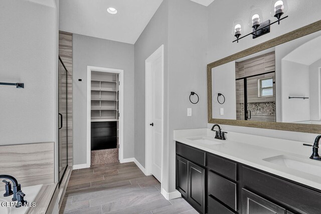 13357 Highworth Dr, El Paso, TX 79928 - bathroom featuring vanity, hardwood / wood-style flooring, and independent shower and bath