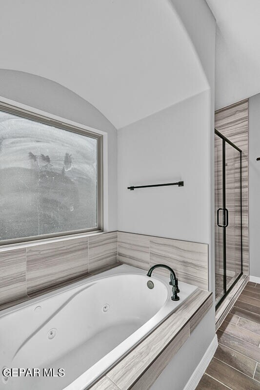 13357 Highworth Dr, El Paso, TX 79928 - bathroom with hardwood / wood-style floors, shower with separate bathtub, and vaulted ceiling