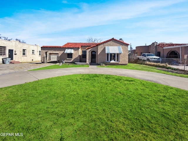 mediterranean / spanish house with a front yard