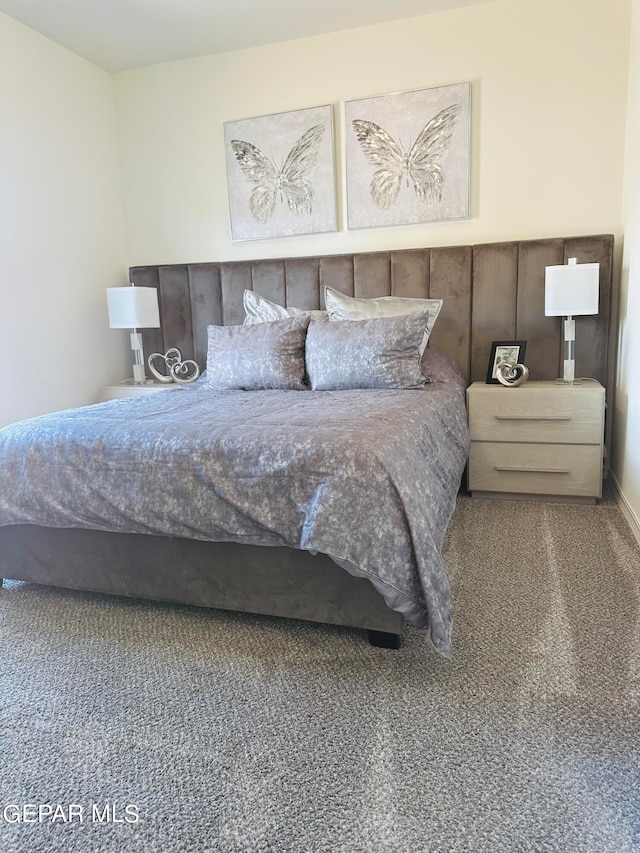 bedroom with dark colored carpet