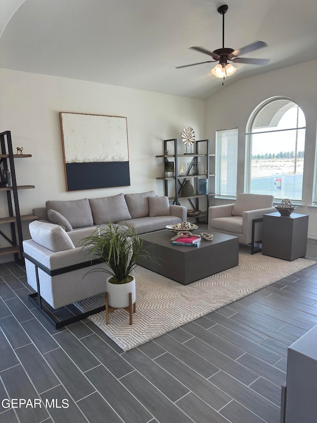 living room with ceiling fan, lofted ceiling, and dark hardwood / wood-style floors