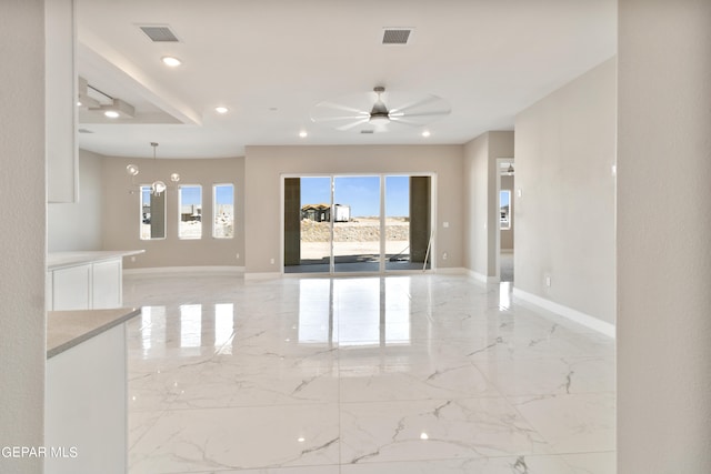 empty room featuring marble finish floor, visible vents, and baseboards