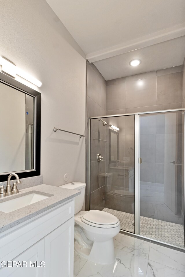 full bath featuring toilet, marble finish floor, a shower stall, and vanity