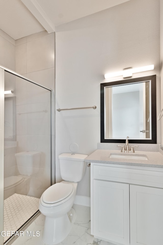 bathroom with baseboards, toilet, marble finish floor, a tile shower, and vanity