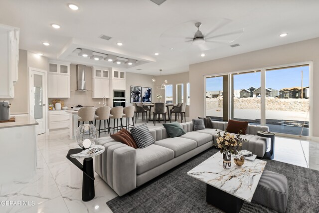 living area with marble finish floor, visible vents, and recessed lighting