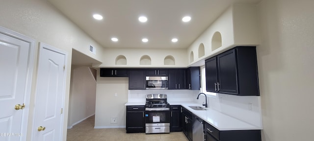 kitchen with light tile flooring, appliances with stainless steel finishes, and sink