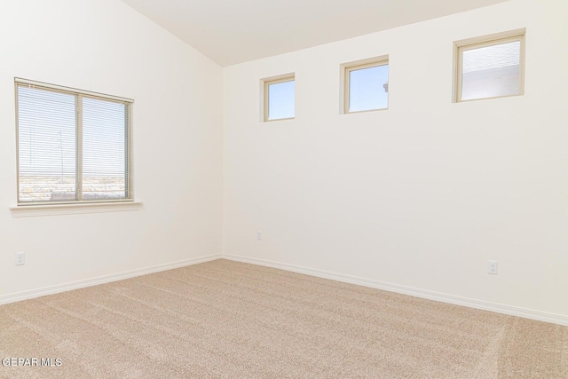 unfurnished room with a healthy amount of sunlight and light carpet