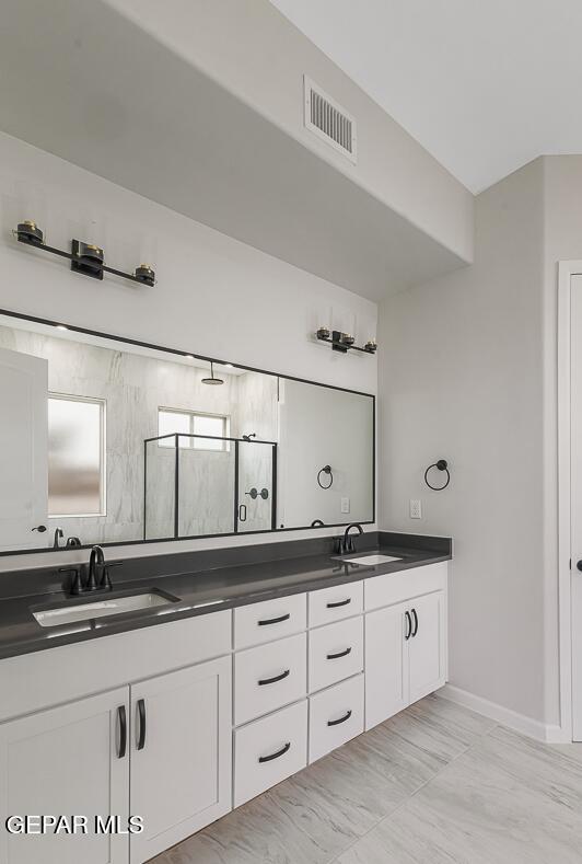 bathroom with walk in shower and vanity